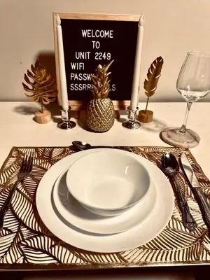 a table with a plate and a sign on a table at Luxurious 2 Bedroom Oasis in Air Residences with Bar KTV and Games in Manila