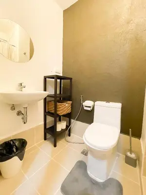 a bathroom with a white toilet and a sink at Houzz 1548 by Houzztelity in Manila
