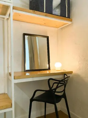 a chair sitting in front of a desk with a mirror at Houzz 1548 by Houzztelity in Manila