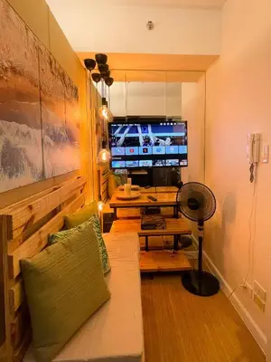 a living room with a couch and a television at Houzz 845 by Houzztelity in Manila