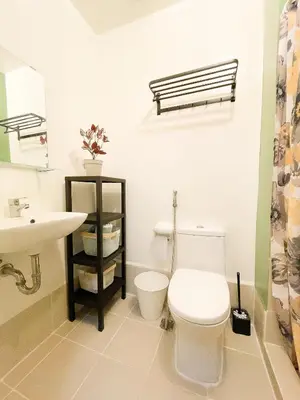 a bathroom with a white toilet and a sink at Houzz 845 by Houzztelity in Manila