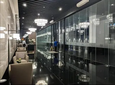 a lobby with a glass wall with chairs and tables at Air Residence T1 Amazing Makati Luxury Condo 66 sq m 300Mbps Fast in Manila