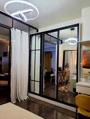 a room with sliding glass doors and a living room at Air Residence T1 Amazing Makati Luxury Condo 66 sq m 300Mbps Fast in Manila