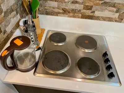 a stove top with four burners on a counter at Air Residence T1 Amazing Makati Luxury Condo 66 sq m 300Mbps Fast in Manila