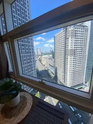a large window with a view of a city at Twin Oaks near MRT Shaw, Megamall, Shangri-la plaza in Manila