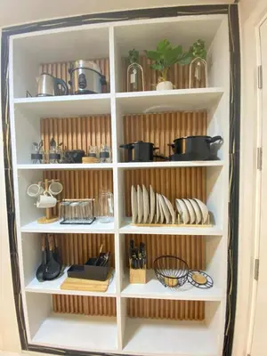 a white book shelf filled with pots and pans at Twin Oaks near MRT Shaw, Megamall, Shangri-la plaza in Manila