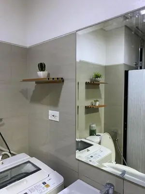 a bathroom with a mirror and a sink and a toilet at COZY PASAY CONDOMINIUM HOTEL UNIT with NETFLIX in Manila