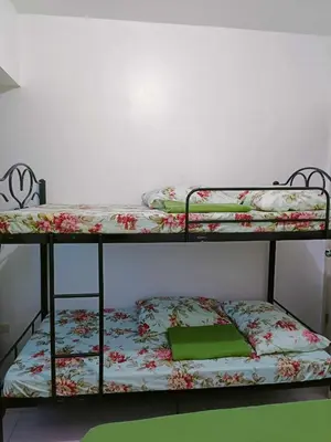 two bunk beds in a room with a green folder at 2 bedroom just accross MOA and SMX by jam ez in Manila