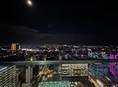 a view of a city at night at City Lights Apartment in BGC in Manila