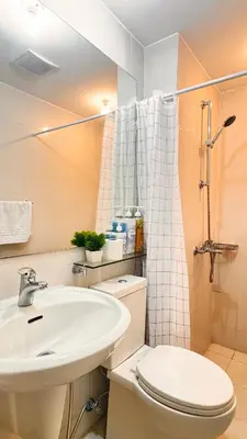 a bathroom with a sink and a toilet and a shower at Art & Zen - Azure Staycation in Manila