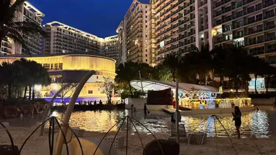 a view of a city at night with buildings at Art & Zen - Azure Staycation in Manila