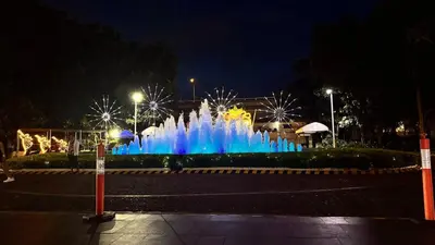 a fountain in the middle of a city at night at Art & Zen - Azure Staycation in Manila