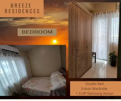 a bedroom with a bed and a dresser at Experience Sunset by the Breeze in Manila