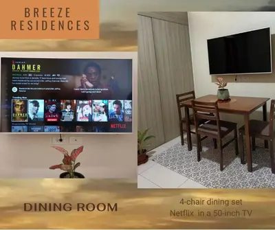 a dining room with a television and a dining room table at Experience Sunset by the Breeze in Manila