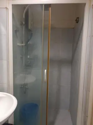 a shower with a glass door in a bathroom at Sea Residence Tower EF by Theresa P in Manila