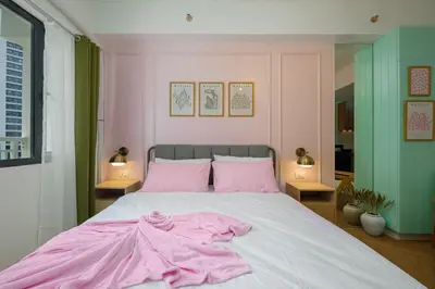a bedroom with a bed with pink clothes on it at Blush Haven with Netflix, WiFi and Balcony near Glorietta in Manila