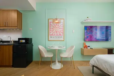 a kitchen with a table and two chairs in a room at Blush Haven with Netflix, WiFi and Balcony near Glorietta in Manila