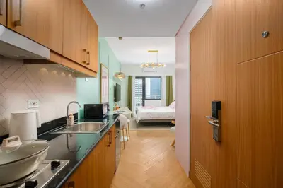 a kitchen with a sink and a bathroom with a bedroom at Blush Haven with Netflix, WiFi and Balcony near Glorietta in Manila