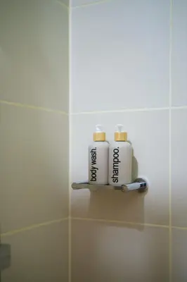 two rolls of toilet paper sitting on a shelf in a bathroom at Blush Haven with Netflix, WiFi and Balcony near Glorietta in Manila