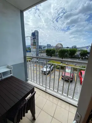 a balcony with a view of a parking lot with cars at 257-1BR 2 Queen size bed 1sofa bed 1 extra matress in Manila