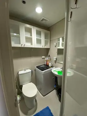 a small bathroom with a toilet and a sink at 257-1BR 2 Queen size bed 1sofa bed 1 extra matress in Manila