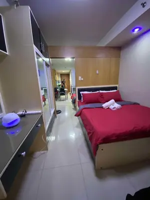 a bedroom with a large red bed in a room at 257-1BR 2 Queen size bed 1sofa bed 1 extra matress in Manila