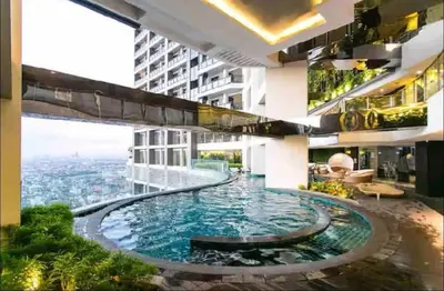 a large swimming pool in the middle of a building at Studio Unit with Balcony in The Gramercy Residences in Manila