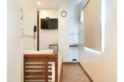 a small room with a desk and a tv on a wall at Collection O Avitel Hotel near Osmena Highway, PNR Pasay Station, Metro Manila in Manila