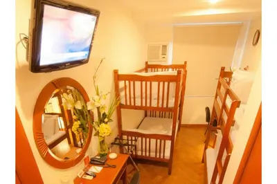 a room with two bunk beds and a mirror at Collection O Avitel Hotel near Osmena Highway, PNR Pasay Station, Metro Manila in Manila