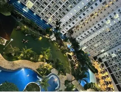 an aerial view of a large building with a pool at Unistay Shore Res with Bal Manila Bay View nr MOA in Manila