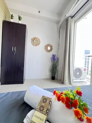 a bedroom with a bed with flowers on it at Unistay Shore Res with Bal Manila Bay View nr MOA in Manila