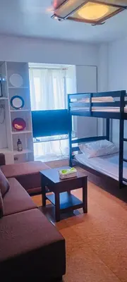a living room with bunk beds and a coffee table at Avida sm sucat condotel in Manila