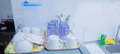a kitchen counter with two trays with cups and mason jars at Avida sm sucat condotel in Manila