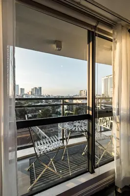 a balcony with a table and a view of the city at Makati City Centre Condo in Manila