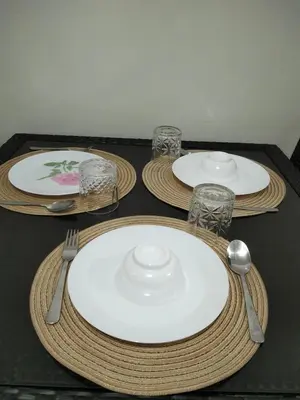 a table with three plates and glasses on it at Shore2 tower2 in Manila