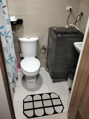 a bathroom with a toilet and a sink at Shore2 tower2 in Manila