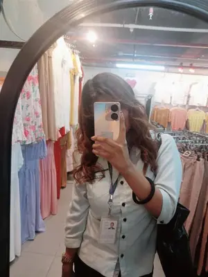 a woman taking a picture in front of a mirror at Cess in Manila