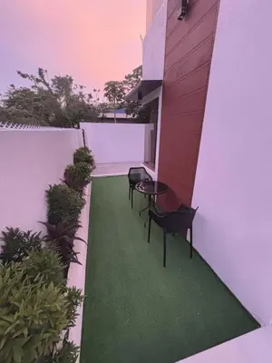 a patio with two chairs and a table on a building at Villa Serene Resort in General Trias