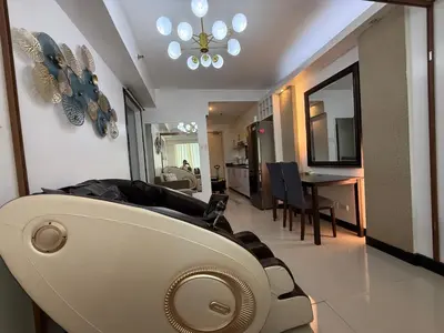 a living room with a couch and a dining room at Staycation By Abby Tower E in Manila