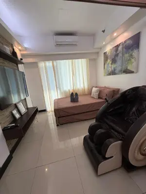 a large living room with a bed and a couch at Staycation By Abby Tower E in Manila