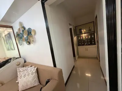 a living room with a couch and a hallway at Staycation By Abby Tower E in Manila