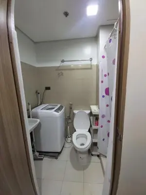 a small bathroom with a toilet and a sink at Chic Urban Retreat near mall of asia in Manila