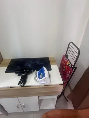 a desk with a pair of shoes on it at Shore 2 Tower 3 Chic and Cozy by Richnells in Manila