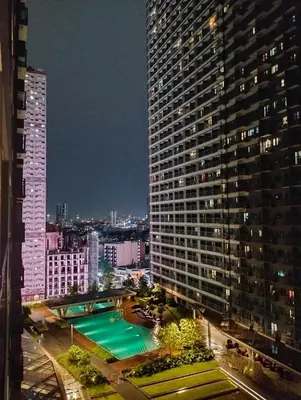 a view of a large building with a swimming pool at Ortigas Business District Residences in Manila