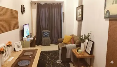 a living room with a couch and a table at Ortigas Business District Residences in Manila