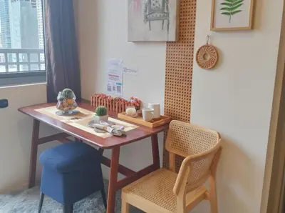 a table and two chairs in a room with a table at Ortigas Business District Prime Accommodations in Manila