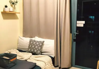 a room with a window and a couch with a pillow at Ortigas Business District Prime Accommodations in Manila