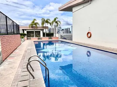 a swimming pool on the roof of a building at BGC Mckinley City Center Apartments in Manila