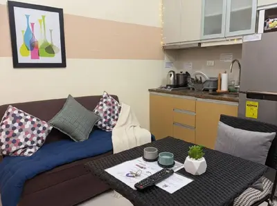 a living room with a couch and a table at BGC Mckinley Center Prime Accommodations in Manila