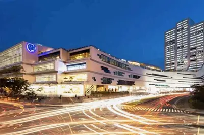 a large building with cars on a city street at BGC Mckinley Center Prime Accommodations in Manila